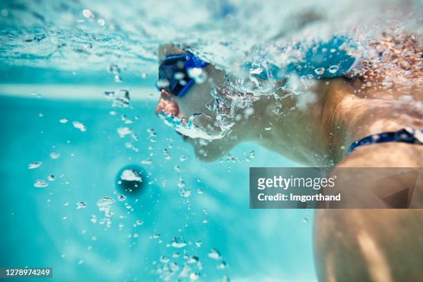teenage girl swimming crawl in pool - swimming free style pool stock pictures, royalty-free photos & images