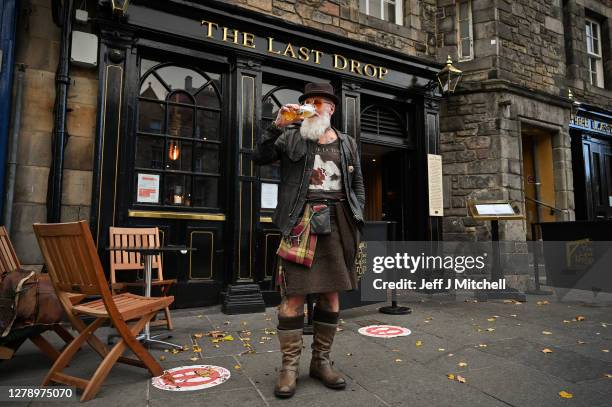 Charles Douglas Barr enjoys a pint outside The Last Drop pub in the Grassmarket on October 7, 2020 in Edinburgh, Scotland. Scottish First Minister...