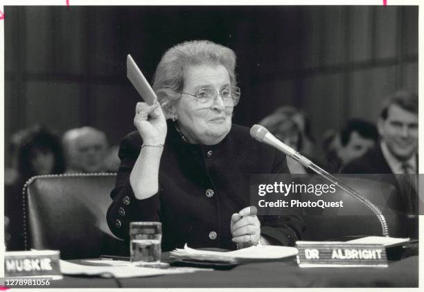 National Security Council member Madeleine Albright holds up a copy of the United Nations Charter as she testifies before the US Senate Committee on...