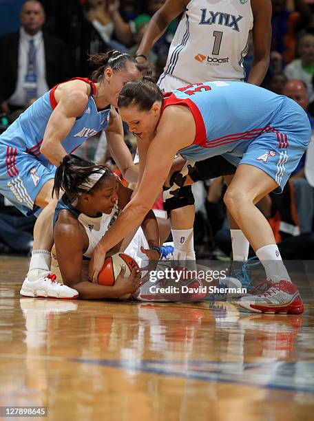 Monica Wright of the Minnesota Lynx guards the ball against Alison Bales and Coco Miller of the Atlanta Dream in Game One of the 2011 WNBA Finals on...