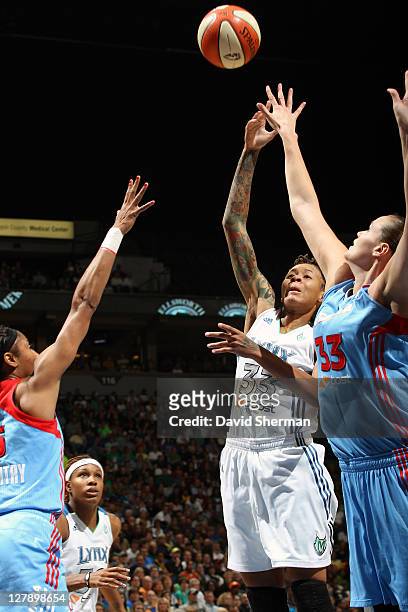 Seimone Augustus of the Minnesota Lynx goes for the jump shot against Alison Bales and Angel McCoughtry of the Atlanta Dream in Game One of the 2011...