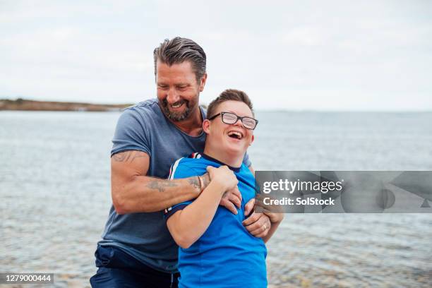 wrestling with dad - boy and girl love closeness hug beach stock pictures, royalty-free photos & images