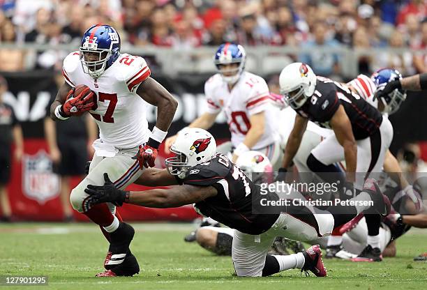 Runningback Brandon Jacobs of the New York Giants rushes the football past defensive end David Carter of the Arizona Cardinals during the NFL game at...