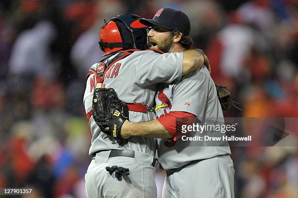 Jason Motte and Yadier Molina of the St. Louis Cardinals celebrate after defeating the Philadelphia Phillies 5-4 in Game Two of the National League...