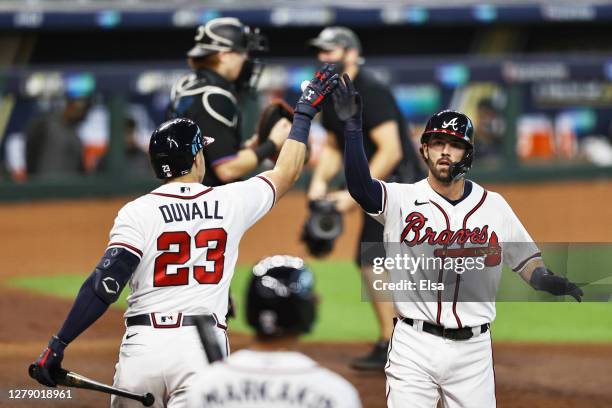 Dansby Swanson of the Atlanta Braves celebrates his homerun with teammate Adam Duvall during the second inning against the Miami Marlins in Game Two...