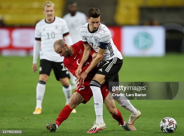 Julian Draxler of Germany is challenged by Efecan Karaca of Turkey during the international friendly match between Germany and Turkey at...