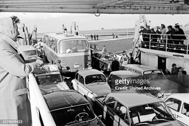 Cars and passengers on the ferry boat heading to Foehr island, Germany 1960s.