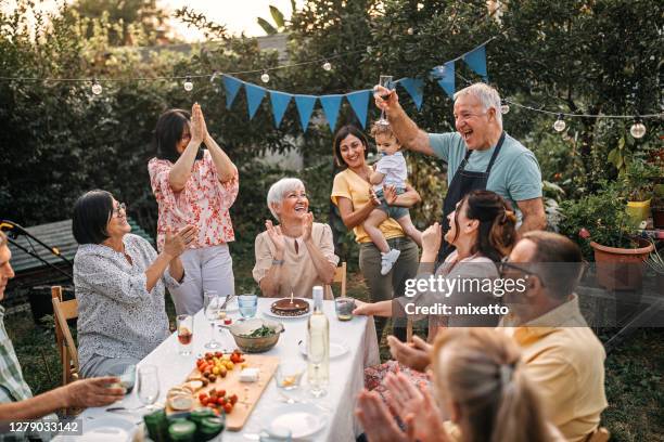 family and friends enjoying at a party in garden - 2020 35 65 stock pictures, royalty-free photos & images