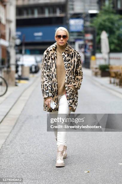 German actress Lara-Isabelle Rentinck wearing a leopard print coat by Apparis, a beige turtleneck pullover by Closed, beige pants by closed, rose...