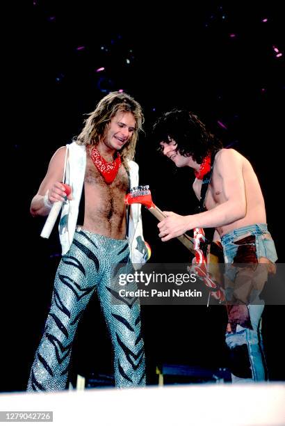 Rock musicians David Lee Roth and Eddie Van Halen , both of the group Van Halen, perform onstage at the Jacksonville Coliseum, Jacksonville, Florida,...