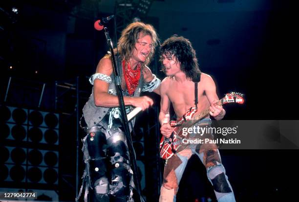 Rock musicians David Lee Roth and Eddie Van Halen , both of the group Van Halen, perform onstage at the Jacksonville Coliseum, Jacksonville, Florida,...