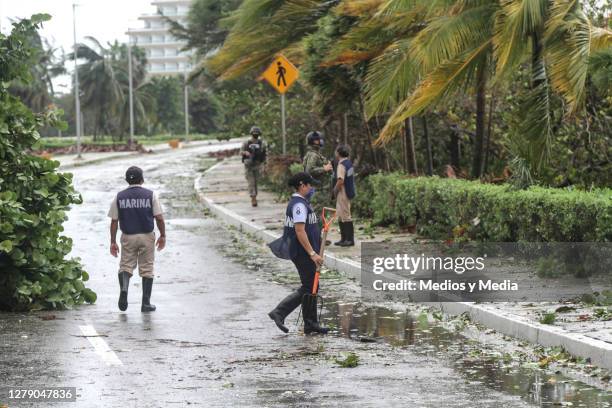 Members of the Army and Marines survey the damage caused by Hurricane Delta and close affected streets on October 7, 2020 in Cancun, Mexico....