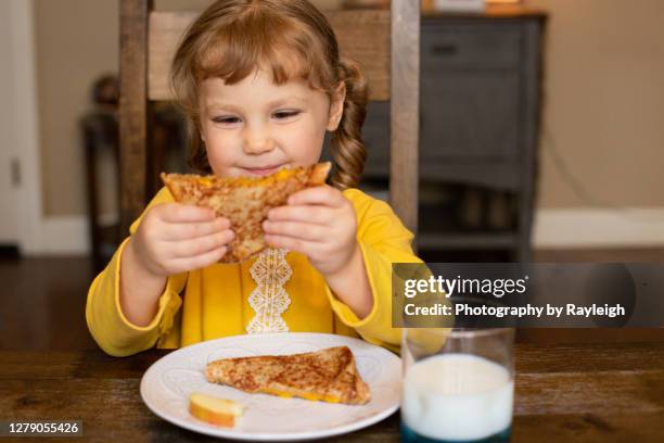 girl eating a sandwich - boterham met kaas stockfoto's en -beelden