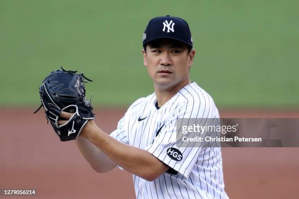 Masahiro Tanaka of the New York Yankees delivers the pitch against the Tampa Bay Rays during the third inning in Game Three of the American League...