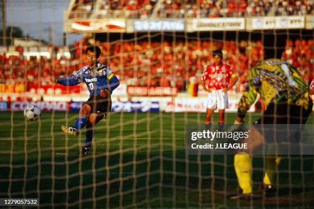 Hiromitsu Isogai of Gamba Osaka converts the penalty to score his side's first goal during the J.League Nicos Series match between Urawa Red Diamonds...