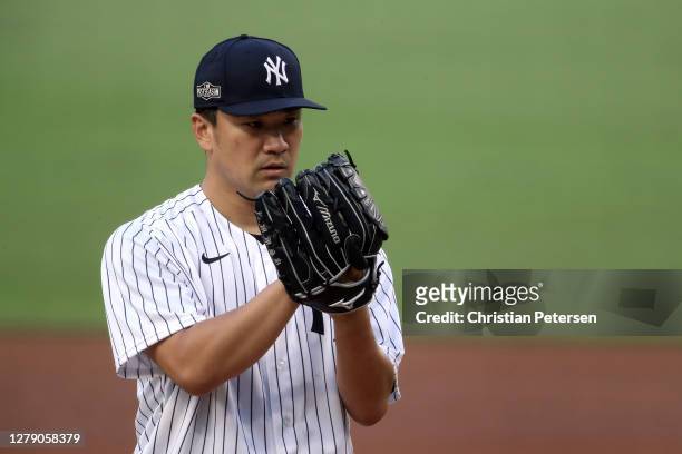 Masahiro Tanaka of the New York Yankees pitches against the Tampa Bay Rays during the fourth inning in Game Three of the American League Division...