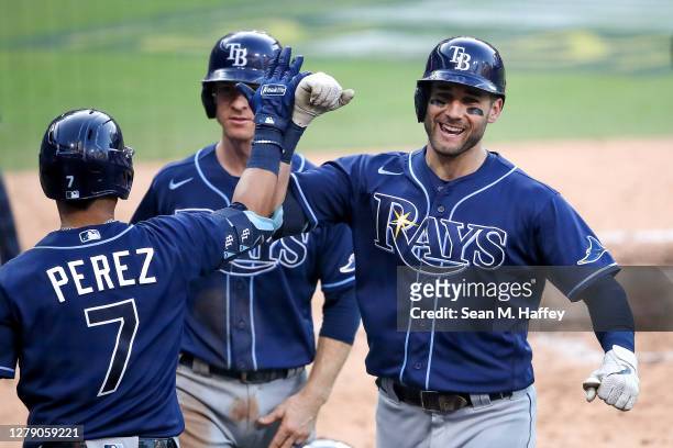 Kevin Kiermaier of the Tampa Bay Rays is congratulated by Michael Perez after hitting a three run home run against the New York Yankees during the...