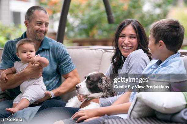 happy parents relaxing with their kids - tolerant dog stock pictures, royalty-free photos & images