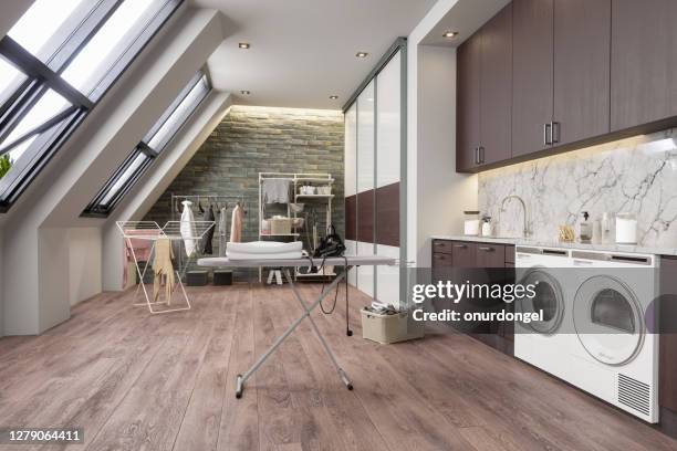 laundry room with washing machine, dryer and ironing board at the attic - utility room stock pictures, royalty-free photos & images