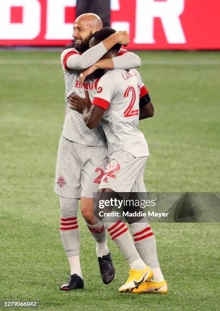 Richie Laryea and Laurent Ciman of Toronto FC celebrate after Toronto FC defeat theNew England Revolution 1-0 at Gillette Stadium on October 07, 2020...