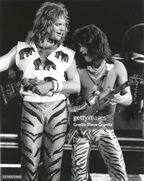 Guitarist Eddie Van Halen and singer David Lee Roth of the rock group Van Halen performs at the Forum in May, 1984 in Inglewood, California.