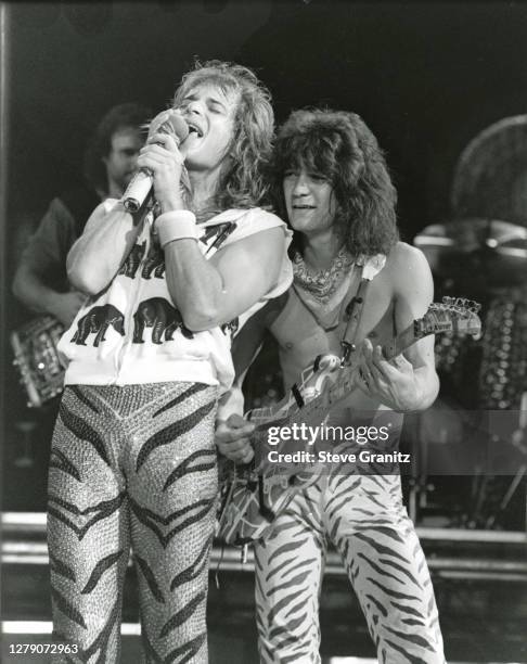 Guitarist Eddie Van Halen and singer David Lee Roth of the rock group Van Halen performs at the Forum in May, 1984 in Inglewood, California.