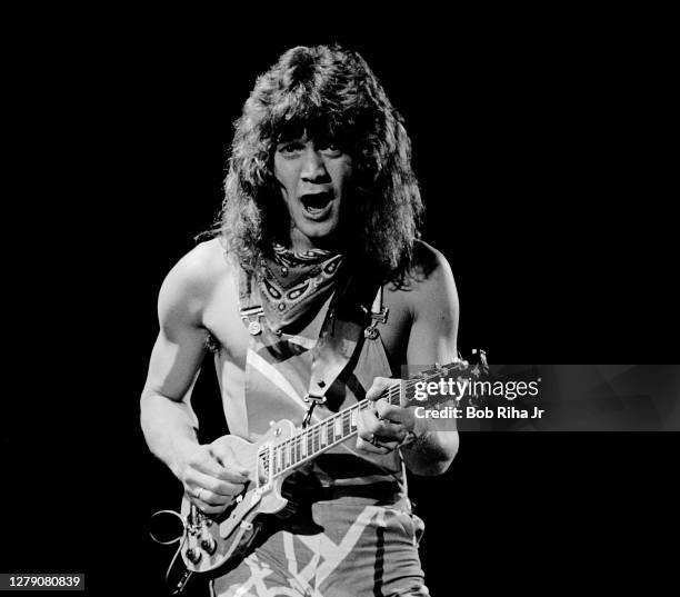 Dutch-born American musician Eddie Van Halen, of the group Van Halen, plays guitar as he performs onstage during US Festival concert, Devore,...