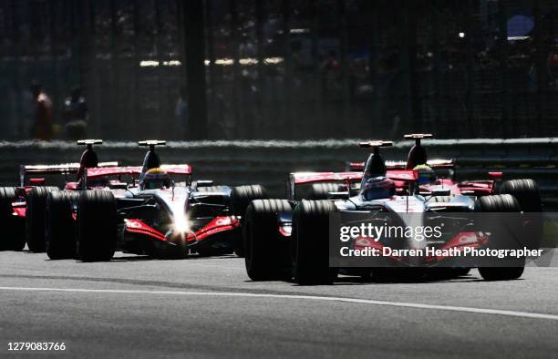 Spanish McLaren Formula One driver Fernando Alonso leads his British teammate Lewis Hamilton in their McLaren MP4-22 cars and Ferrari drivers Felipe...