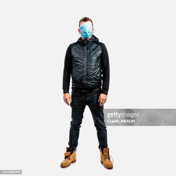 scared man protecting himself from pandemic crisis - coat imagens e fotografias de stock