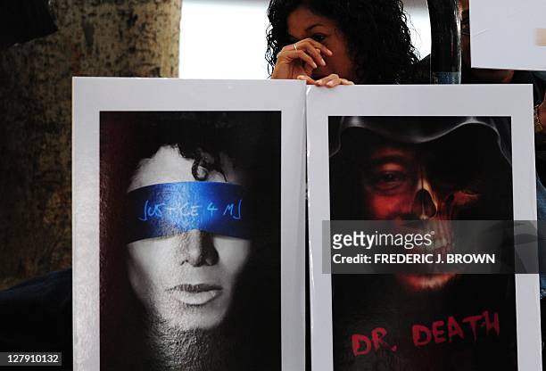 Woman holds placards outside the courthouse ahead of the third day of the trial of Dr. Conrad Murray on September 29, 2011 in Los Angeles. Singer...
