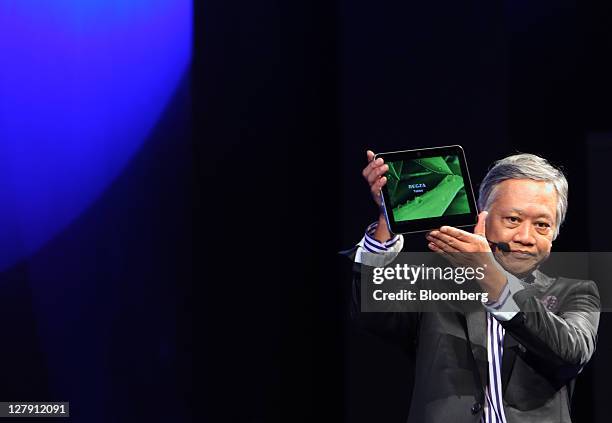 Masaaki Osumi, president of Toshiba Corp.'s Visual Products Company, shows the company's REGZA Tablet AT700 tablet computer during a news conference...