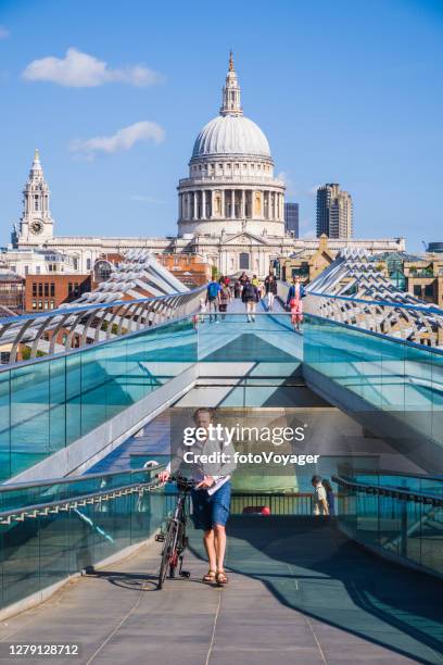 london man pushing bicycle millenium bridge st pauls cathedral thames - thames path stock pictures, royalty-free photos & images