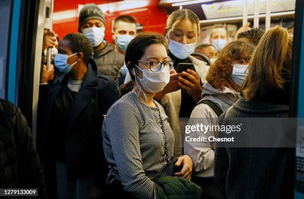 Passengers wearing protective face masks are seen in a subway train during the coronavirus outbreak on October 08, 2020 in Paris, France. Despite...