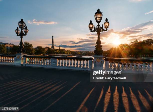 eiffel tower from pont alexandre iii and river seine in paris - eiffel tower at night stock pictures, royalty-free photos & images