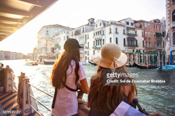 two teenage girls sightseeing in venice touring the grand canal by boat - city friends sun bildbanksfoton och bilder