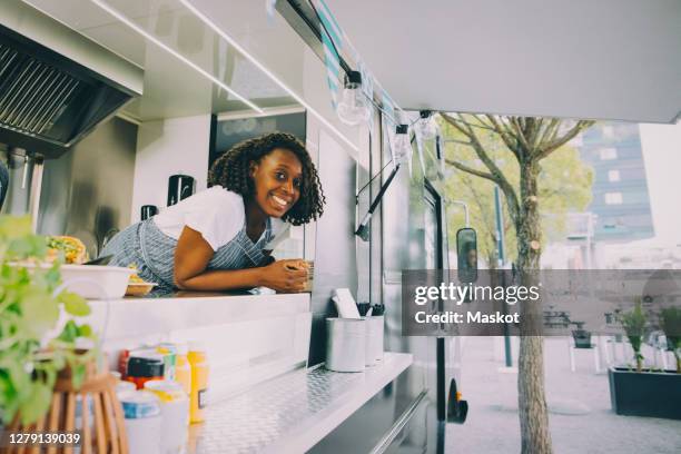 portrait of smiling female owner standing in food truck - snackbar stock pictures, royalty-free photos & images