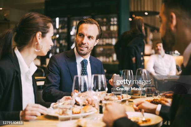 business coworkers talking while having lunch at restaurant - pausa pranzo foto e immagini stock