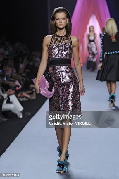 Model walks the runway as Les Brigittes perform during the Viktor&Rolf Ready to Wear Spring / Summer 2012 show during Paris Fashion Week at Espace...