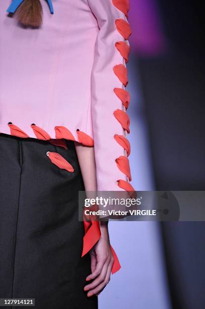 Model walks the runway as Les Brigittes perform during the Viktor&Rolf Ready to Wear Spring / Summer 2012 show during Paris Fashion Week at Espace...