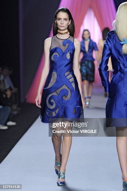 Model walks the runway as Les Brigittes perform during the Viktor&Rolf Ready to Wear Spring / Summer 2012 show during Paris Fashion Week at Espace...