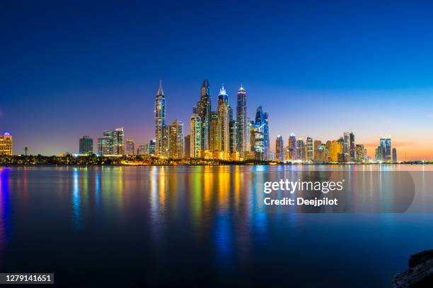 the dubai marina skyline at sunset, united arab emirates - dubai marina stock pictures, royalty-free photos & images