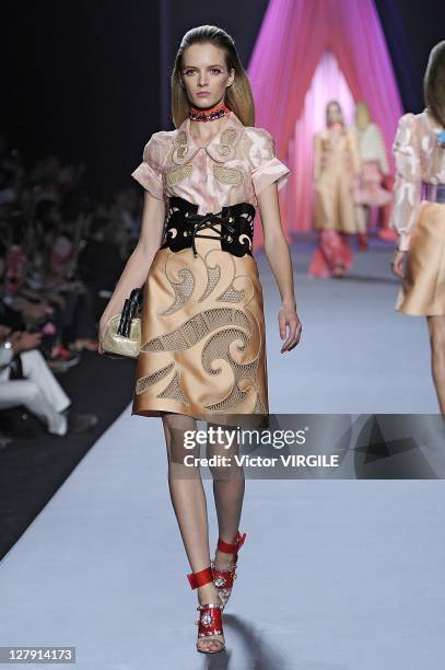 Model walks the runway as Les Brigittes perform during the Viktor&Rolf Ready to Wear Spring / Summer 2012 show during Paris Fashion Week at Espace...