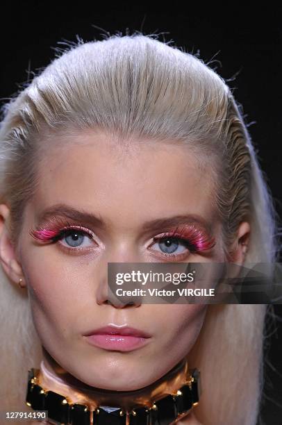 Model walks the runway as Les Brigittes perform during the Viktor&Rolf Ready to Wear Spring / Summer 2012 show during Paris Fashion Week at Espace...