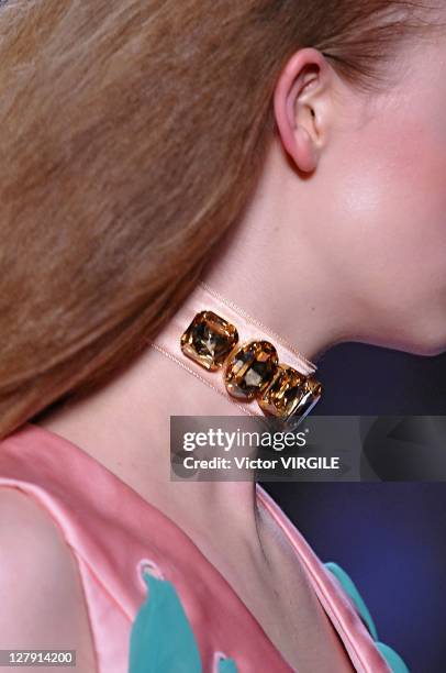 Model walks the runway as Les Brigittes perform during the Viktor&Rolf Ready to Wear Spring / Summer 2012 show during Paris Fashion Week at Espace...