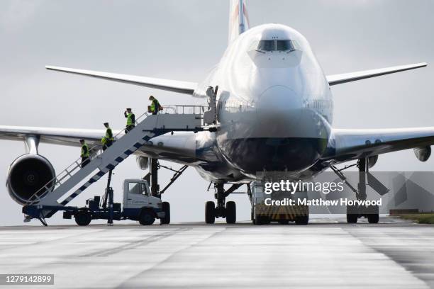 British Airways crew depart a Boeing 747-400 aircraft for the last time after it arrives at St. Athan airport on October 8, 2020 in St. Athan, Wales....