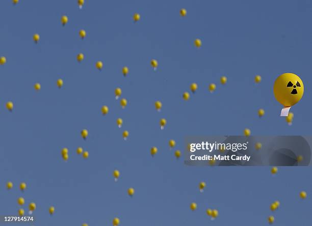 Anti-nuclear protestors release 206 balloons to mark the number of days since the Japanese nuclear accident, at the gates of Hinkley Point nuclear...