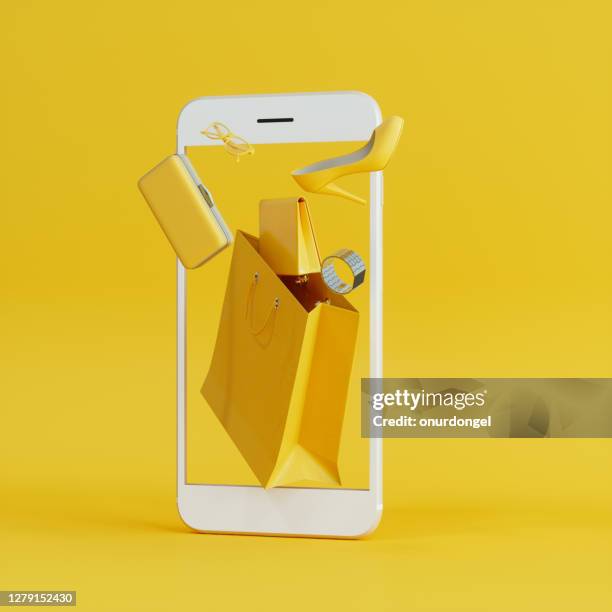 online shopping at smartphone with flying yellow wallet, clutch bag and shoe background - e commerce imagens e fotografias de stock