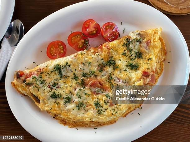 omelet with tomatoes on a plate - omelette stock pictures, royalty-free photos & images