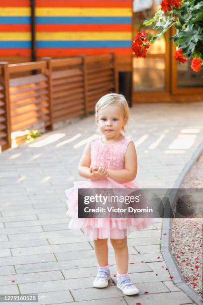 outdoor portrait of the little girl in pink dress - the little white dress stock-fotos und bilder