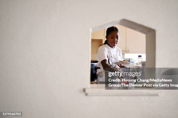 Imani Strong prepares afternoon pancake after her virtual school day at Denver, Colorado on Wednesday. October 7, 2020. For children with sickle cell...